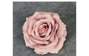 Macro detail of artificial dusty rose flower head showing layered fabric petals and texture