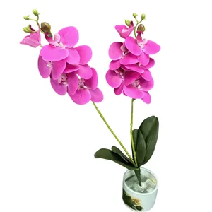 Artificial fuchsia orchid in a white ceramic pot for home and wedding decor