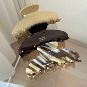 Elegant acetate shark hair clips in khaki, brown, and marble patterns for women