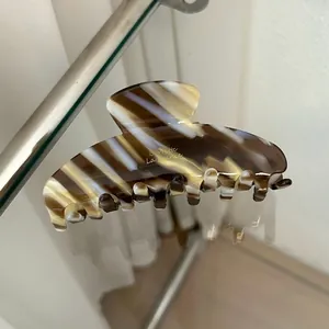 Close-up of marble patterned hair claw clip featuring Barrette La France engraving