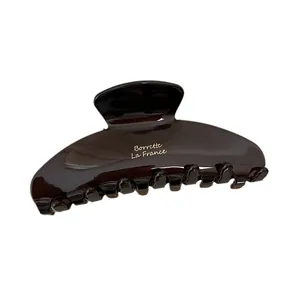 Elegant dark brown acetate hair claw clip with golden Barrette La France lettering