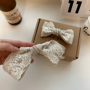 French vintage lace bow hair clip in beige and white with elegant aesthetic style