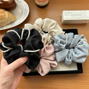 Elegant satin scrunchies with pearls in four colors for women's stylish hair styling