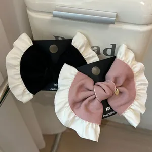 French vintage ballet style bow hair clips in black and pink with white lace trim