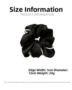 Detail view of a black satin scrunchie with pearls showing 12cm diameter and 5cm width