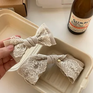 French vintage lace bow hair clip in khaki and white, handcrafted for elegant styling