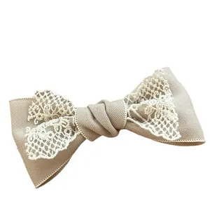 French vintage khaki lace bow hair clip with white embroidery on white background