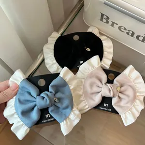 French vintage lace bow hair clips in black, light blue and pink with heart pendants