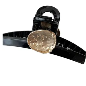 Elegant large black hair claw clip with gold metal numbers and polished resin finish
