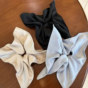 Three premium satin silk scrunchies with long ribbons in black, champagne, and lilac