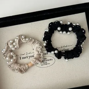 Elegant scrunchie set with pearls and silver studs in beige and black fabric
