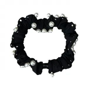 Elegant black scrunchie with white pearls and silver studs for a French hairstyle