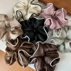 Vue détaillée de chouchous vintage en satin avec liseré contrasté en plusieurs couleurs