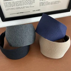 Detailed view of four colors wide-brimmed knitted headbands on a wooden surface