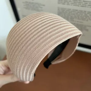 Macro view of light brown ribbed knit wide headband showing soft texture and anti-slip lining