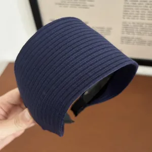 Detail of navy blue ribbed knitted headband with non-slip black inner lining