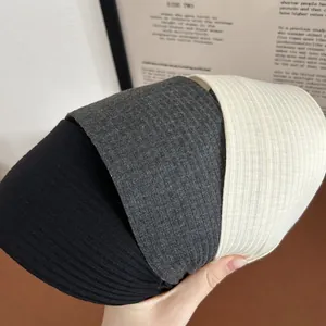Three-piece set of wide ribbed knit headbands in black, dark gray and cream white