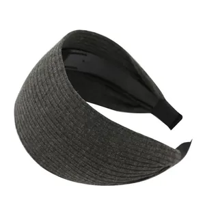 Fashionable wide knitted dark grey headband with ribbed texture for high cranial top