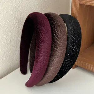 Detailed view of padded velvet headbands with metallic glitter thread in three colors