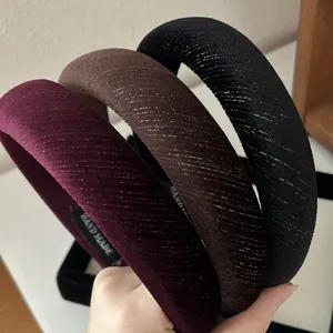 Detail of velvet padded headbands in wine red, brown and black with shimmer texture