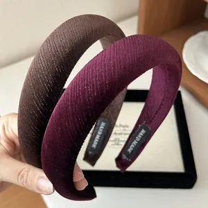 Detail of handmade padded velvet headbands in brown and burgundy with shimmering texture