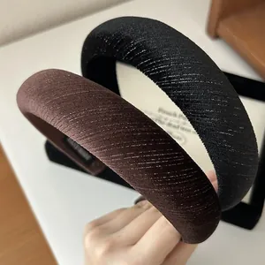 Detail of handmade velvet headbands with ribbed texture and sparkling metallic fibers
