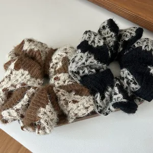 Detailed texture of plush knitted scrunchies in brown and black color block designs