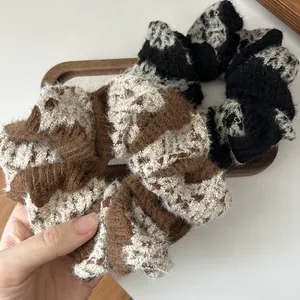 Detailed view of high-elasticity plush knit scrunchies in brown and black patterns