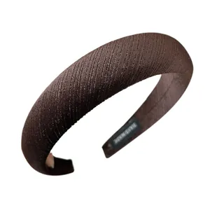 Padded velvet headband in dark coffee with vertical texture and handmade label