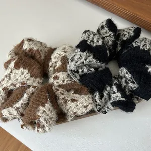 Plush knitted scrunchies set with abstract patterns in brown and black tones