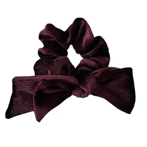 Elegant deep purple velvet hair scrunchie with a stylish oversized bow design