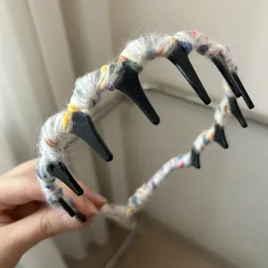 Detail of a wavy knitted headband with colorful yarn texture and internal fixing teeth