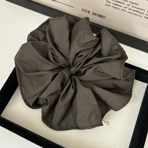 Large dark coffee satin scrunchie with ruffled edge texture and silky finish