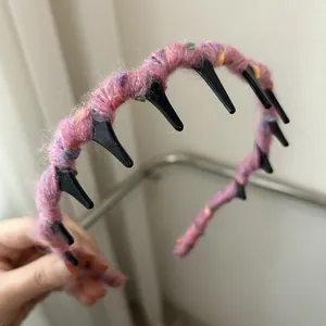 Close-up of pink knit wave headband showing fuzzy wool texture and anti-slip teeth detail