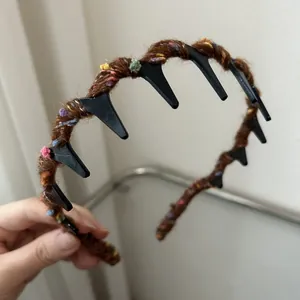 Detail showing inner teeth of brown knitted headband for secure hold and comfort
