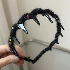 Handmade knitted wave headband with colorful yarn poms and punk style black spikes