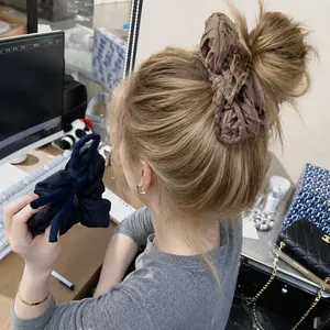 Voluminous pleated fabric scrunchies in brown and navy blue for stylish hair styling