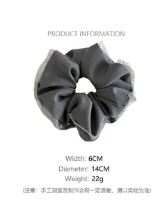 Detailed view of grey satin scrunchie with lace edge, pearls, and size measurements