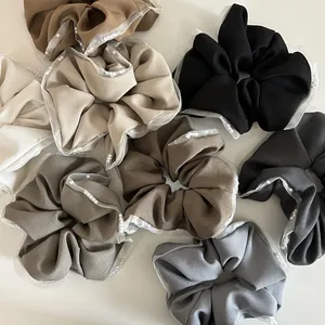 Close-up of elegant mesh lace scrunchies with pearls in various earth tone colors