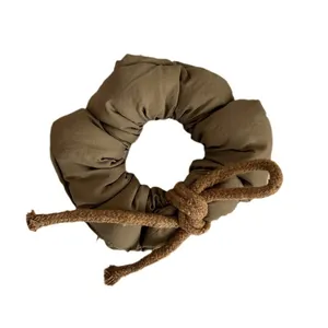 Puffy khaki fabric scrunchie with woven knot decoration for women's hair styling