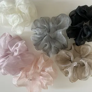 Set of six shimmering organza scrunchies in diverse elegant colors for hair styling