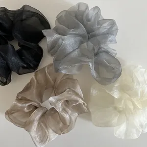 Set of four shimmering organza scrunchies in black, silver, champagne, and cream colors