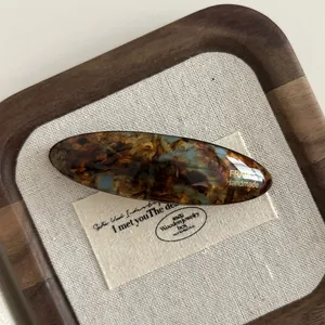 Close-up of tortoise shell acetate hair clip with golden France Handmade lettering