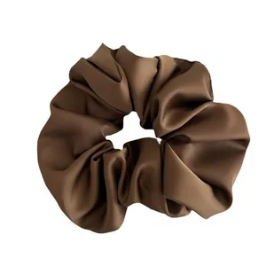 Elegant deep brown satin scrunchie with silky texture for high ponytail hairstyles