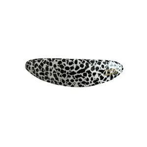 Classic oval acetate hair clip with black and white spots and gold handmade logo