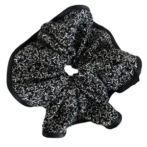 Retro floral oversized satin scrunchie with black piping edge on white background