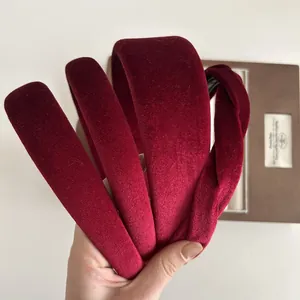 Macro detail of wine red velvet headbands in smooth and knotted twist styles