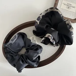 Two-pack vintage satin scrunchies in black and grey with leopard print lace edges