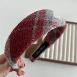 Dettaglio della trama in tweed scozzese rosso e grigio con etichetta interna