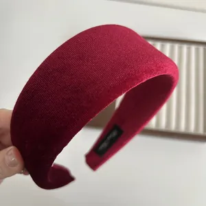 Close-up of the plush burgundy velvet texture and stitching on this padded headband